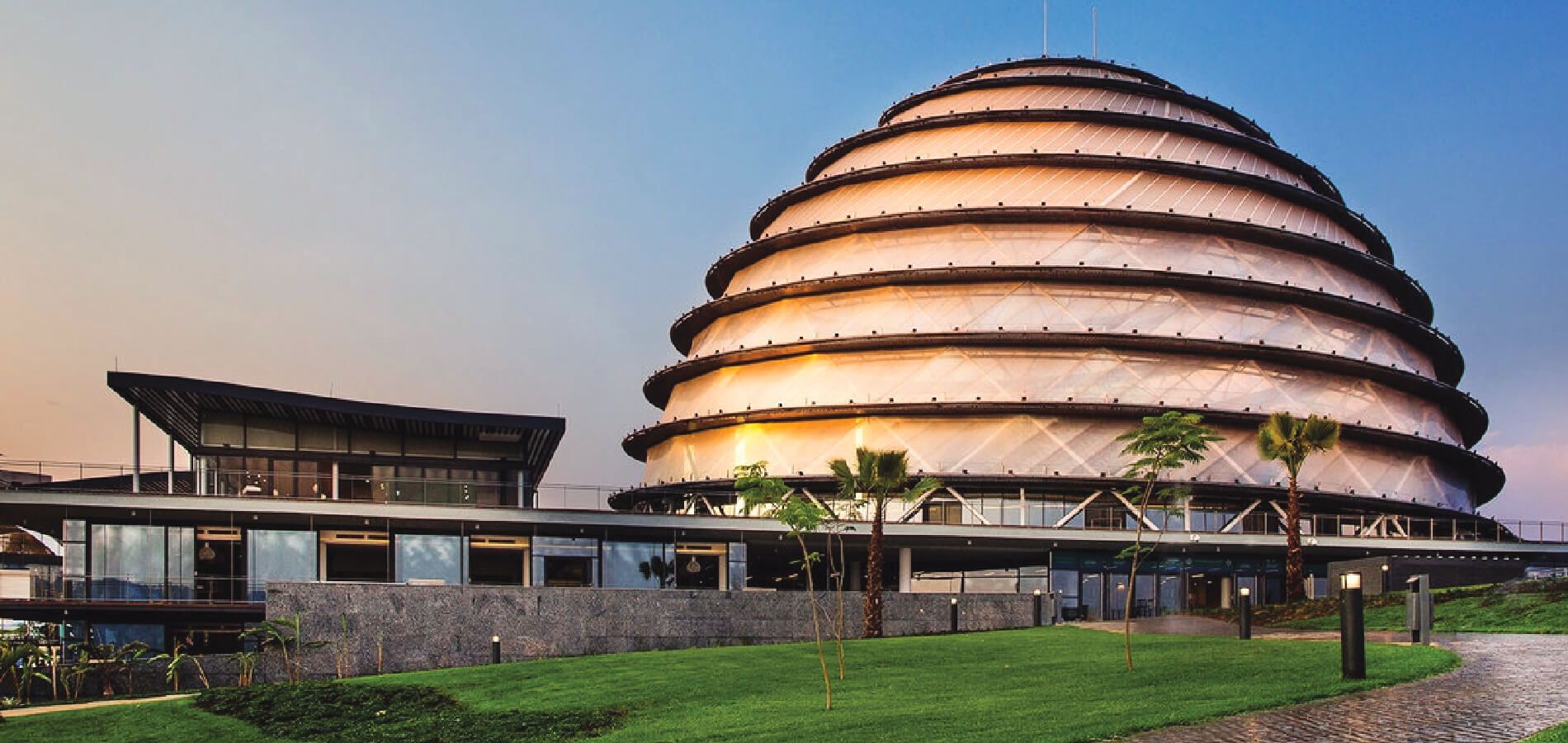Kigali Convention Centre illuminated dome at sunset during an international summit in Rwanda - GoodAV Audiovisual Excellence
