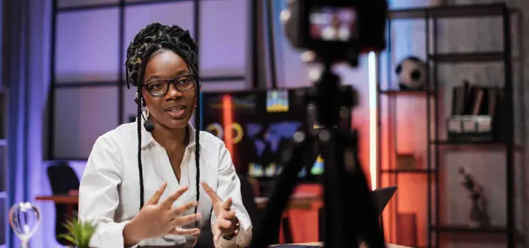 Modern African digital content creator recording video podcast with professional studio camera and lighting in Kigali - GoodAV
