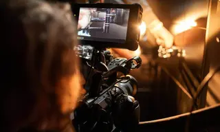 International film crew conducting a multi-camera interview with cinema camera and monitor on set in Rwanda - GoodAV