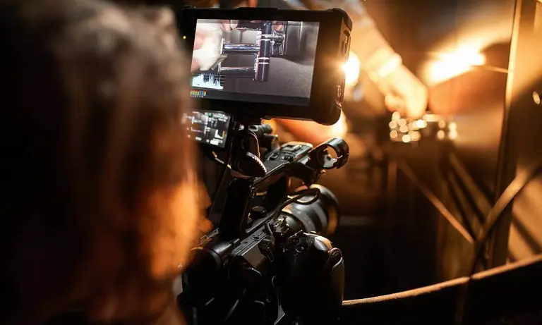 International film crew conducting a multi-camera interview with cinema camera and monitor on set in Rwanda - GoodAV