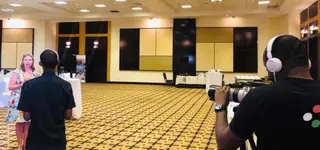 Professional video producer conducting an executive interview in Kigali conference hall - GoodAV Entrepreneur Storytelling