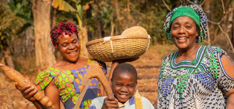 Local agricultural cooperative members holding fresh harvest in an NGO documentary produced in Rwanda by GoodAV