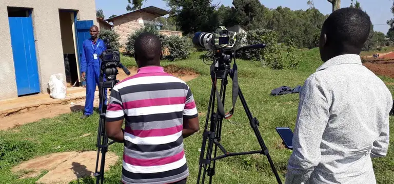 GoodAV professional film crew conducting a field interview with cinema camera and boom audio in rural Rwanda