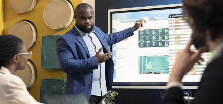 Executive presenting investment data and media market growth opportunities in Africa on high-definition display - GoodAV
