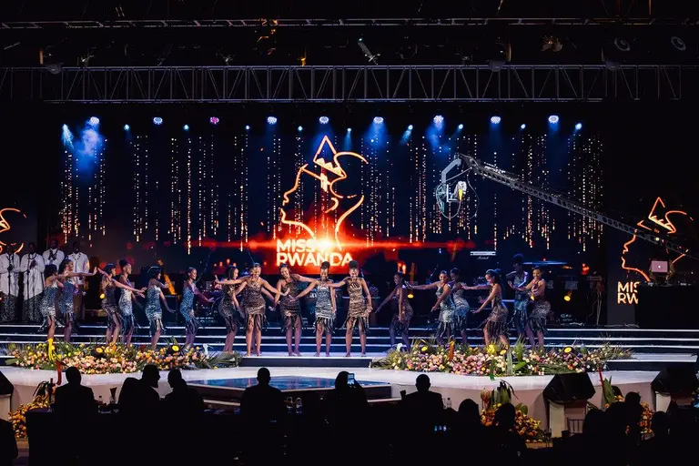 Traditional dancers perform on stage at Miss Rwanda event with cinematic lighting and dynamic LED screen backdrop.of